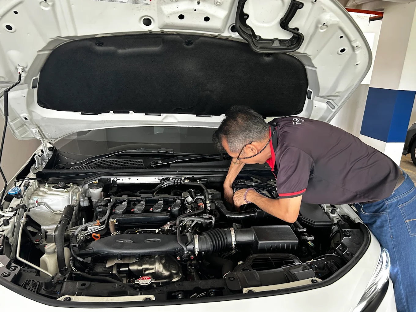 39 Car Battery technician testing a car battery on-site