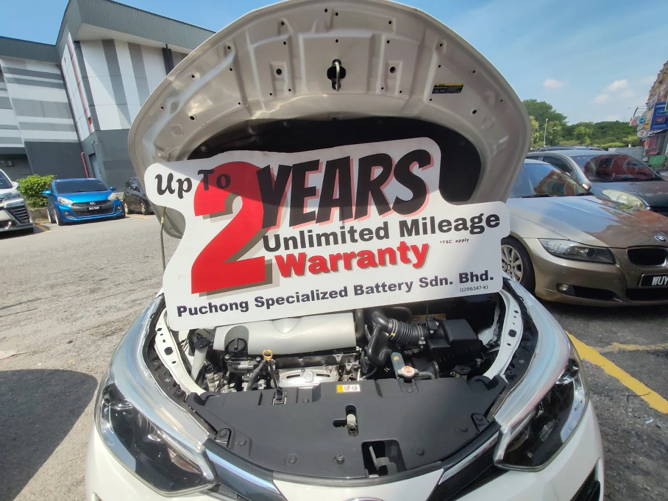 Car battery serviced outdoors in Malaysia's hot climate